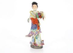 A Japanese porcelain model of a Geisha girl holding a basket of flowers, 33cm high