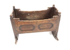 An 18th Century oak child's cradle, inscribed to the side 