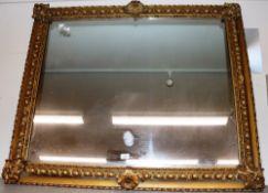 A large gilt framed over mantel mirror with foliat