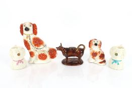 A Victorian Staffordshire spaniel, 27cm high; a smaller similar 16cm high; a Jackfield type cow