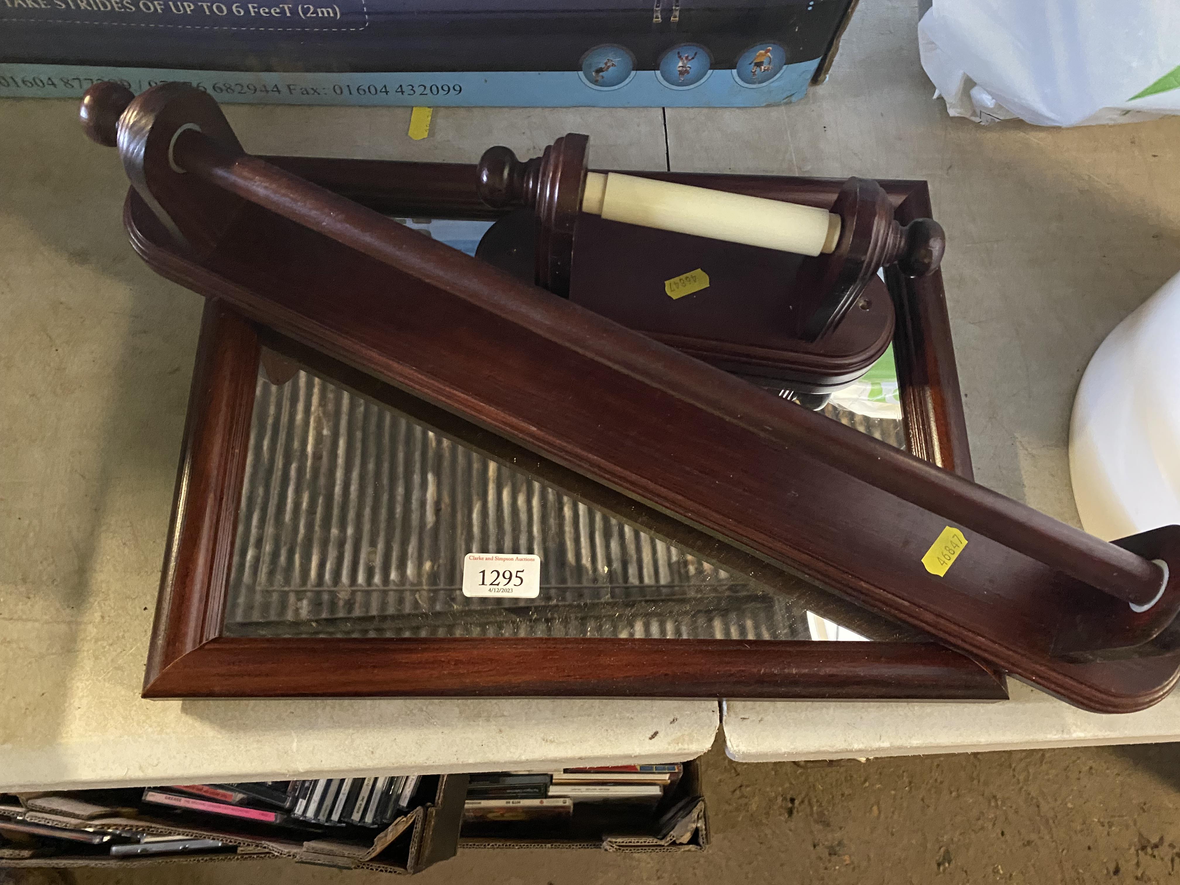 A wooden framed bathroom mirror, a similar toilet