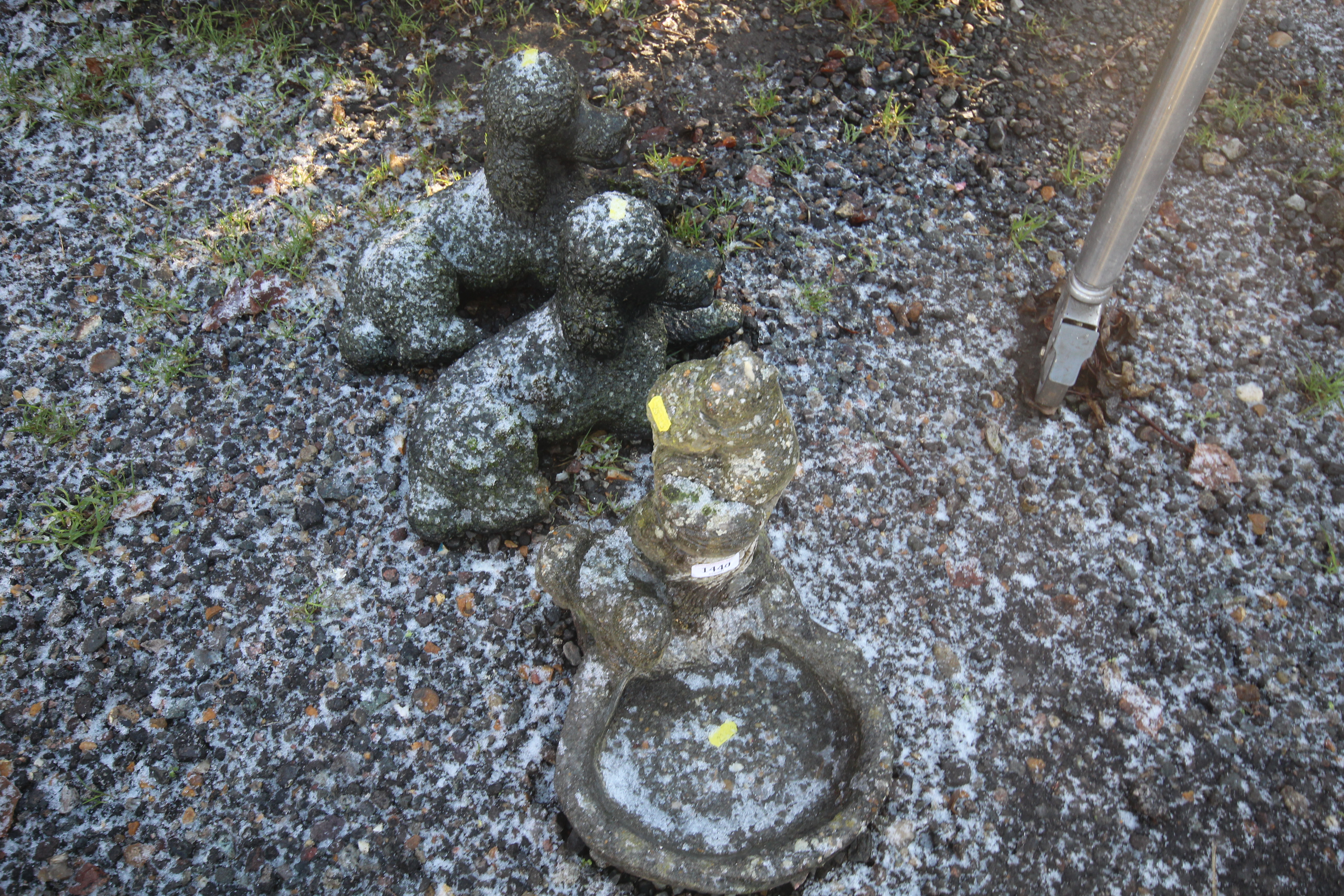 A pair of poodle garden ornaments and an ornament