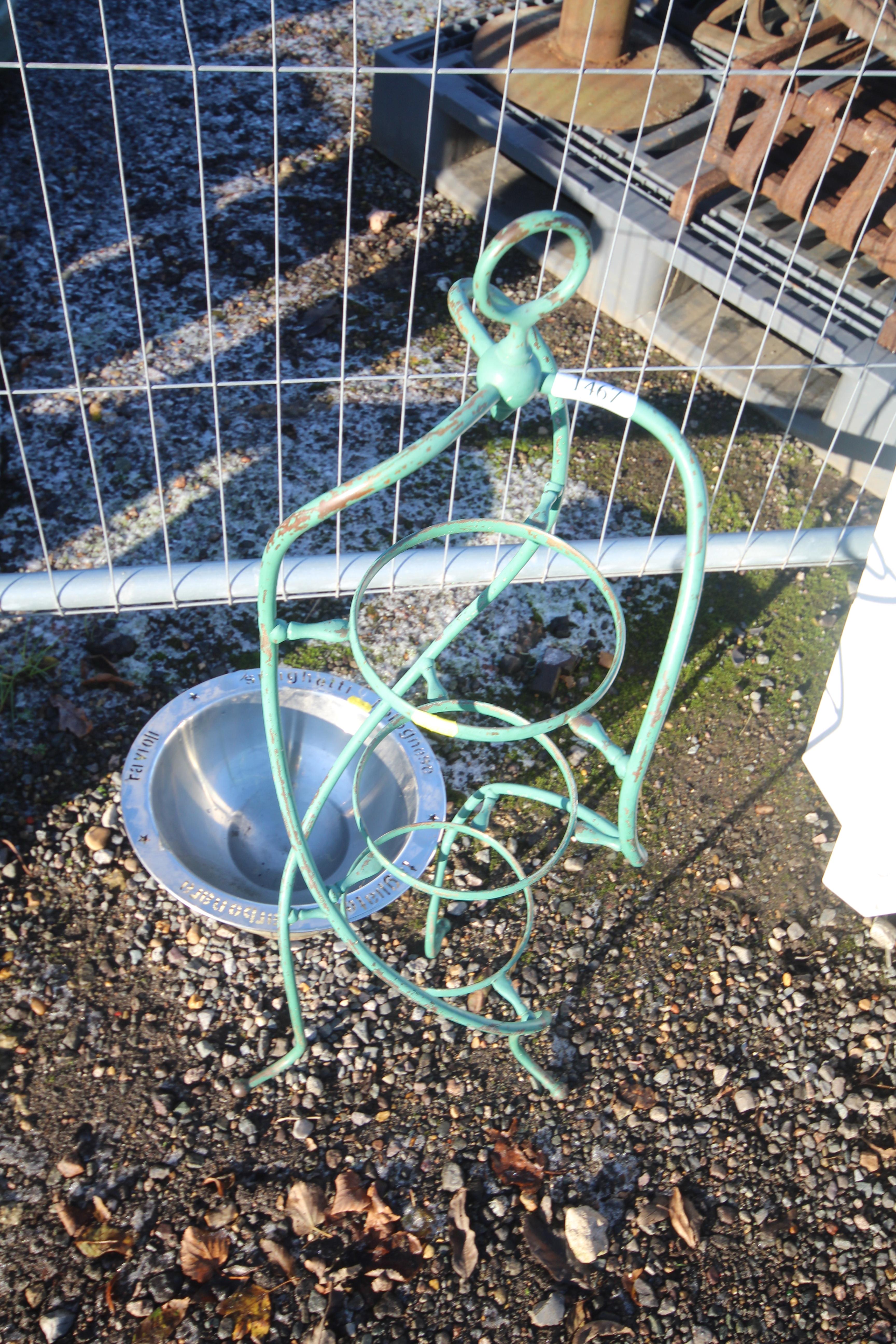 A three tier green painted metal plant stand and a