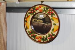 A circular framed wall mirror