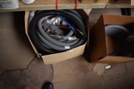 *Two Boxes of Vacuum Hose, Pipes, etc.