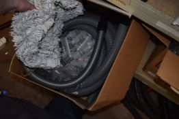*Box of Vacuum Hose and Small Plastic Bottles