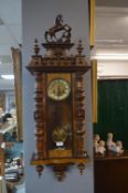 Vienna Wall Clock with Horse Pediment, Turned Detail, and Enameled Brass Face