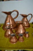 Seven Graduated Copper Jugs