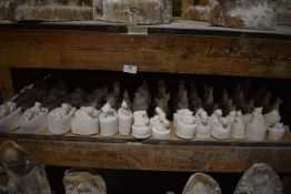 *Shelf of Unpainted Cast Figurines