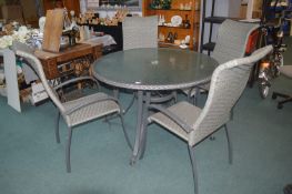 Circular Glass Topped Patio Table and Four Rattan