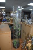 Tall Glass Vase Containing Artificial Plants