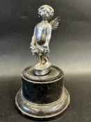 A car accessory mascot in the form of a cherub, display base mounted, approx 6