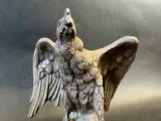 An incredibly heavy sculpture of an eagle upon a rock, well detailed, approx. 5