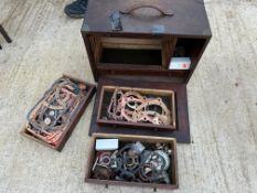A wooden chest containing assorted gaskets and various small parts.