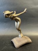 A car accessory mascot in the form of a female nude leaning forward, hair swept back like Mercury,
