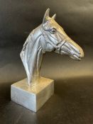A polished aluminium horse's head desktop ornament, approx. 7 1/2