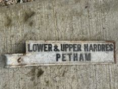 A cast iron post mounted road sign directing to Lower & Upper Hardres and Petham.