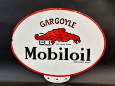A Gargoyle Mobiloil oval double sided enamel pediment for an oil cabinet, some restoration near