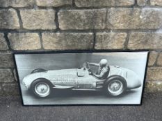 A framed and glazed photographic print of believed Nuvolari driving at speed, 40 x 19 1/2