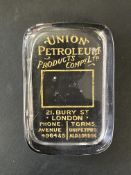 A Union Petroleum Products glass paperweight.