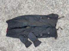 A pair of Belstaff wax cotton leggings and a pair of Belstaff wax cotton mittens.