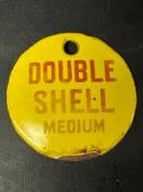 A small circular enamel brand tag for Double Shell Medium, 2 3/4