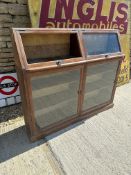 A two piece floor standing display case with one glazed panel missing, 54