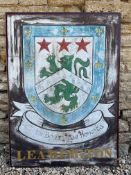 A pair of painted aluminium signs mounted back to back, advertising the Hampshire village of