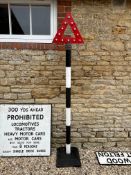 A roadside post topped by cast alloy warning triangle with reflectors 18
