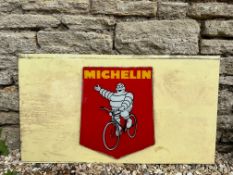 A Michelin pictorial glass advertising sign attached to a milk glass panel, 34 1/2 x 19