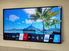 LG 65UM7000PLA television with remote control and power cord