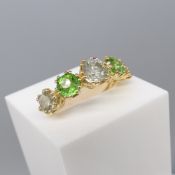 18ct yellow gold twin-prong-set graduated diamond and green stone ring.