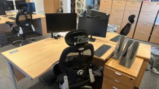 Pair of curved offices desks with chairs, monitors and keyboard