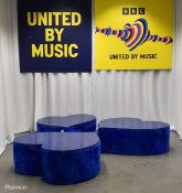 3x Asymmetrical heart shaped blue fur-covered wooden tables from countries' seating area