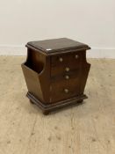 A hardwood side cabinet, fitted with three drawers and a cupboard, flanked by magazine racks, raised
