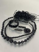A  group of Victorian carved jet, including a graduated necklace, signs cracks, (L x 21 cm) two