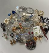 A collection of costume jewelry including paste necklaces, enamel clown brooch, yellow metal