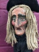 A papier-mâché witch puppet