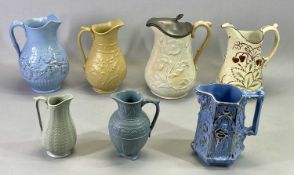 VICTORIAN POTTERY JUGS (7) - with floral moulded bodies, the tallest with hinged pewter cover, 25cms