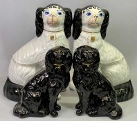 VICTORIAN STAFFORDSHIRE FIGURES OF SEATED SPANIELS, A PAIR - black and white with open front leg,