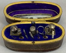 19TH CENTURY OVAL LEATHER NECESSAIRE - with knotted handle and gilt metal mounts, the hinged cover