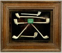 AN OAK FRAMED & GLAZED DISPLAY CABINET - containing seven antique clay pipes and a Gallagher's