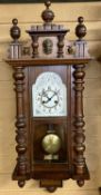 WALNUT CASED VIENNA TYPE WALL CLOCK - the arched white enamel dial with black Arabic numerals, eight