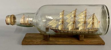 SHIP IN A BOTTLE - early 20th century, four masted ship flying the British Naval red ensign with a