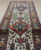 CAUCASIAN RUNNER, three lozenge medallions on an ivory field with cypress trees and scrolling