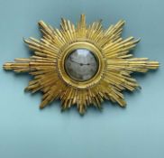 FRENCH GILTWOOD SUNBURST WALL TIMEPIECE, silvered engine turned 8.5cm dial with black enamelled