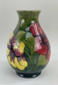 WILLIAM MOORCOFT HIBISCUS PATTERN OVOID VASE, yellow, purple and red flowers on a green background