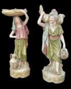 PAIR OF ROYAL DUX WATER CARRIERS, modelled as a male and female standing on naturalistic cylindrical