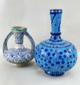 TWO EASTERN POTTERY VASES, comprising an Indian bottle flask painted with blue flowers in thr Mughal