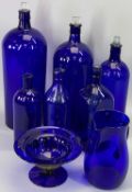 BRISTOL BLUE GLASS GRADUATED CHEMIST'S BOTTLES WITH STOPPERS, 41cms the tallest, blue glass jug,
